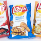 Illustration for article titled Lays Chicken and Waffles, Sriracha and Cheesy Garlic Bread Potato Chips: The Snacktaku Review
